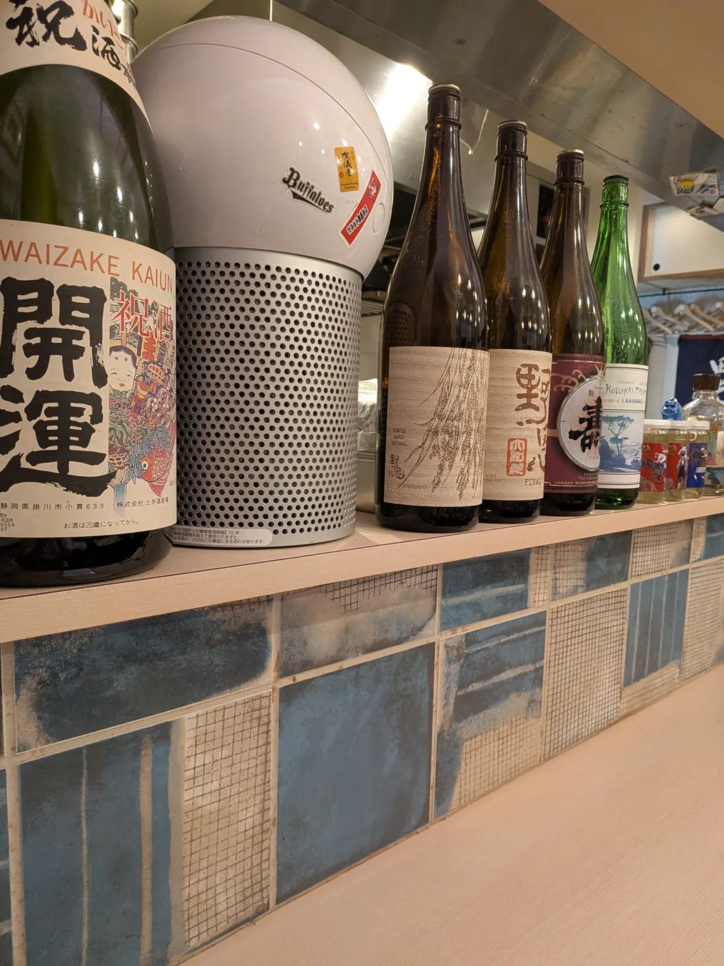 Sake bottles on a shelf inside Furusato in Shimbashi